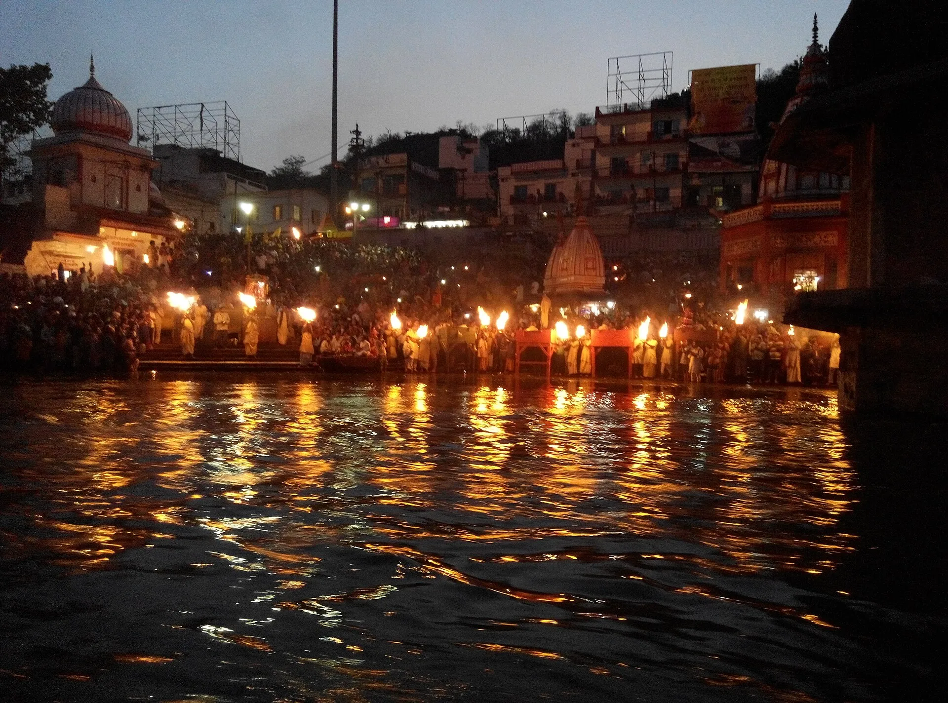 Haridwar Ganga Aarti at night, lamps reflecting in sacred river - spiritual atmosphere of the city where Chinnamasta Jayanti puja is performed