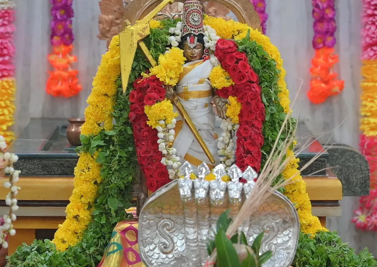 Image 6 - Deity at Etteluthuperumal Temple in white garments with flowers