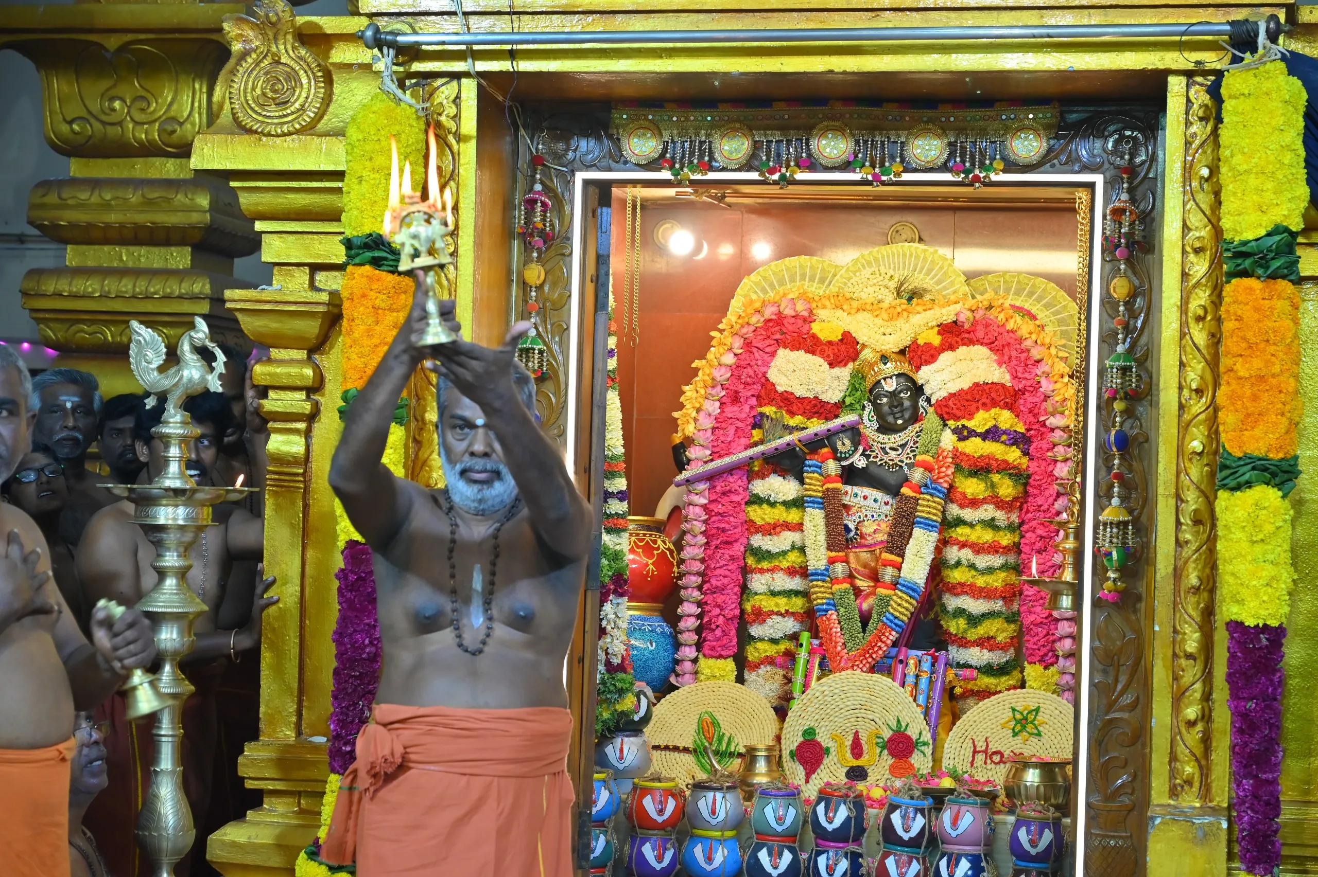 Image 8 - Priest performing aarti at Etteluthuperumal Temple before the adorned deity