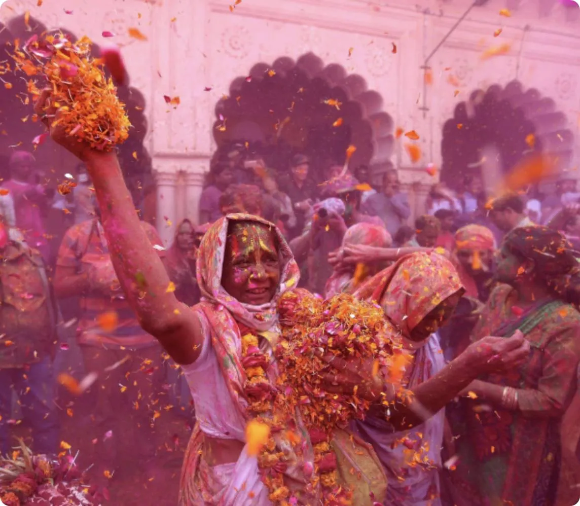 Phoolon Wali Holi at Banke Bihari Temple — devotees in a shower of marigold and rose petals