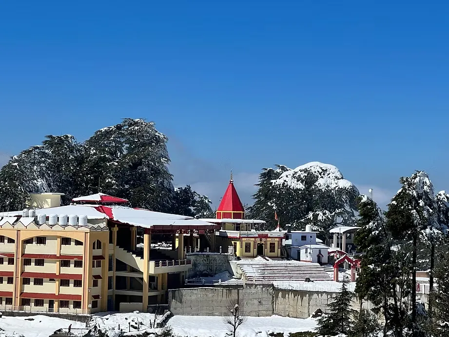 Varahi Devi Shaktipeeth Devidhura temple complex in winter with snow-covered Himalayan surroundings